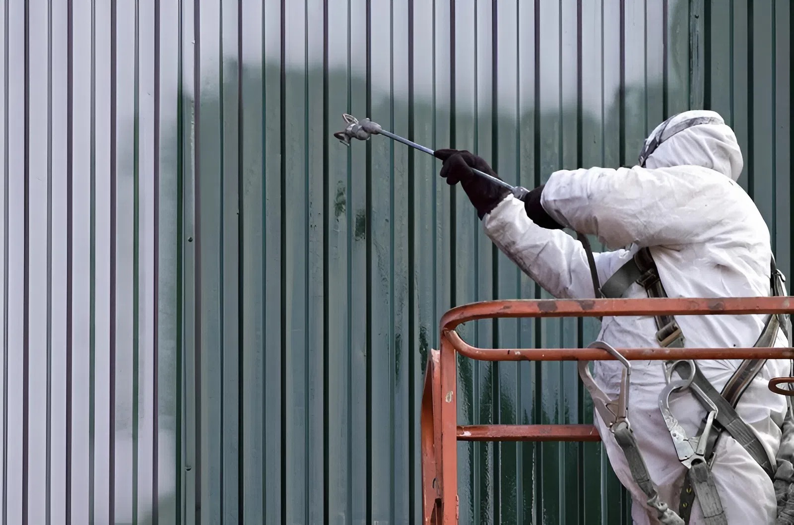 Industrial spray coating on corrugated metal interior wall by an industrial painter in Apopka, FL
