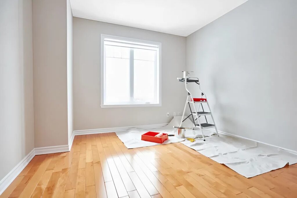 New construction painting in progress on a modern home interior with smooth drywall, clean edges, and even wall coating