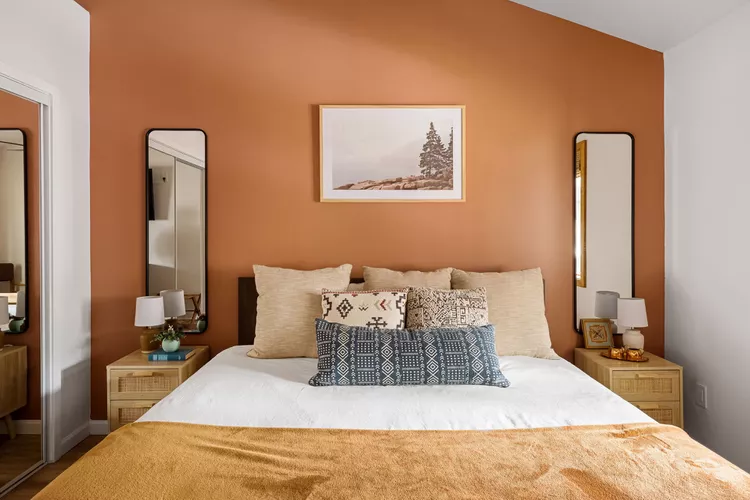 Warm terracotta accent wall with neutral and earthy accents by a house painter in Windermere, FL.