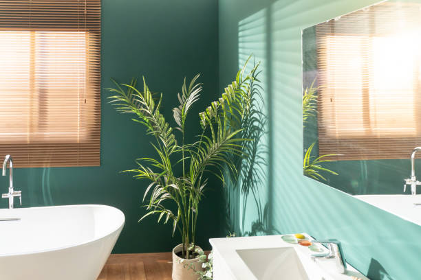 Bathroom with deep green painted walls and crisp white trim by an interior painter in Apopka, FL.